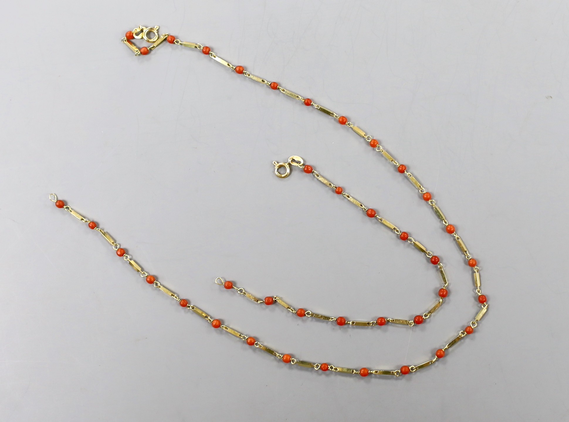 A modern Italian 750 yellow metal and coral bead necklace, 39cm and matching bracelet, 17.75cm, gross weight 9.3 grams.